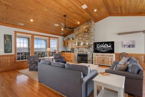 a living room with two couches and a stone fireplace at MS22 Sandpiper's Retreat in Nags Head