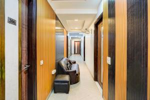a corridor with a leather chair in a hallway at FabHotel Season Grand in New Delhi