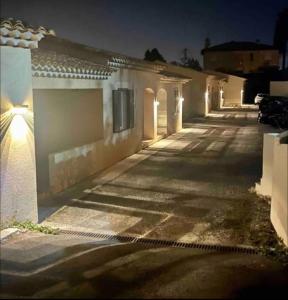 an empty street with a row of buildings at night at DOMAINE LOU BEL AZUR - Entre Ciel et Terre in Saint-Laurent-du-Var