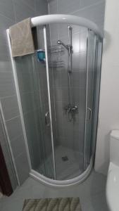 a shower with a glass door in a bathroom at Belvedere Holiday Club Private Apartment in Bansko