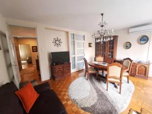a living room with a table and a dining room at Central Park Apartment in Čačak