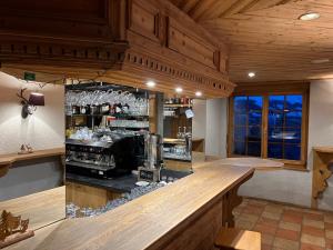 a kitchen with a bar in a restaurant at Hôtel Magrappé in Veysonnaz