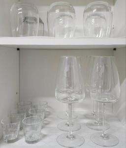 a group of wine glasses sitting on a shelf at Green Home Stay in Seoul