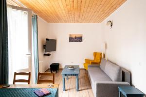 a living room with a couch and a table at Dinvis Apartments in Poiana Brasov