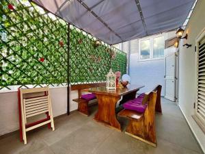 a dining room with a table and purple cushions at Holiday home in Crikvenica 42922 in Crikvenica