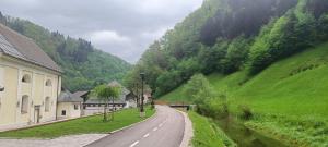 an empty road in a valley with a mountain at Haus Lagma Studio in Železniki