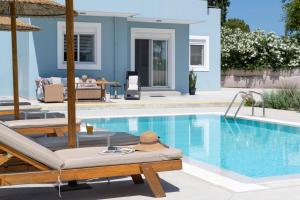 a villa with a swimming pool and a house at Villa Ethria Rhodes in Afantou