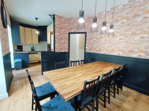 a dining room with a wooden table and chairs at Le Télécab', T5, wifi, cave, ascenseur, 8 personnes in Luchon