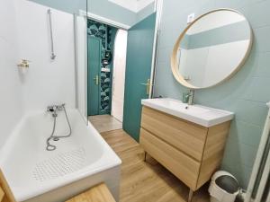 a bathroom with a white sink and a mirror at Le Télécab', T5, wifi, cave, ascenseur, 8 personnes in Luchon