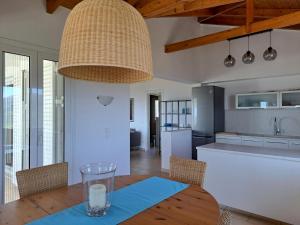 a kitchen and dining room with a table and chairs at Villa Emilios in Lakhanádha