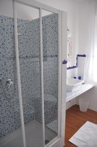 a bathroom with a glass shower with a sink at Le stanze di Rebecca in Tor Vergata