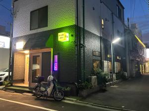 a scooter parked in front of a building at DainHostel2 in Tokyo