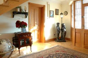 
a living room with a large mirror and a wooden door at Caldra B&B in Buncrana
