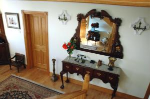 a room with a mirror and a table with a sink at Caldra B&B in Buncrana