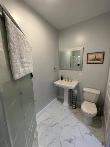 a bathroom with a toilet and a sink at Eden Estate B&B in Reidville +19 photos