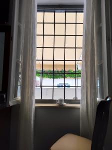 a window with a view of a harbor at Sidra Hotel in Hydra