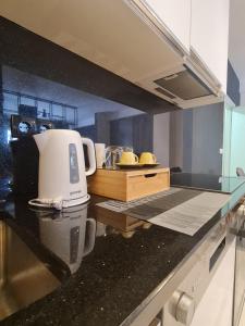 a kitchen with a coffee maker on a counter at Apartment 06 in Gjilan
