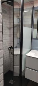 a glass shower in a bathroom with a sink at Casa vacanze Margherita in Laterza +18 photos