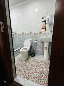 a bathroom with a toilet and a sink at KAMRONBEK GuEST HOUSE in Khiva