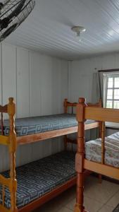 Ένα ή περισσότερα κρεβάτια σε δωμάτιο στο Casa na praia com piscina pontal do Paraná