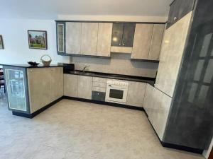a kitchen with stainless steel cabinets and a stove at Casa turística Lucena in Vilagarcia de Arousa