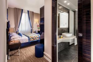 Postel nebo postele na pokoji v ubytování Gioberti Art Hotel