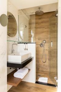 a bathroom with a sink and a shower at Lord Byron in Paris