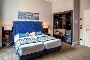 Postel nebo postele na pokoji v ubytování Gioberti Art Hotel