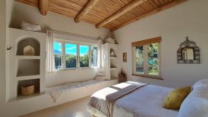 a bedroom with a bed and a window seat at Akasha Mountain Retreat, new location in Heidelberg
