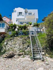 a staircase leading up to a house on a hill at Ammoudeli Apartments in Plomarion