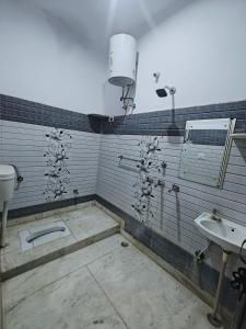 a bathroom with a sink and a toilet at Lata Home Stay in Haridwār +21 photos