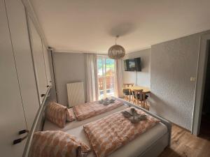 Zimmer mit 2 Betten, einem Tisch und einem Fenster in der Unterkunft am mühlbach - einfach sein mit Gemeinschaftsküche und freien Eintritt in das Solarbad Dorfgastein in Dorfgastein