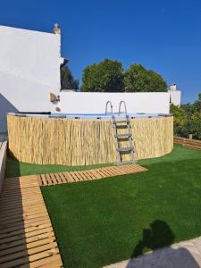 a lawn with a ladder on top of it at Landal House - Óbidos 