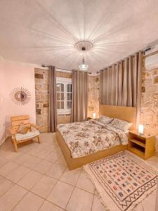 a bedroom with a king sized bed and a table at Dar Bakkali Nadi in Tangier