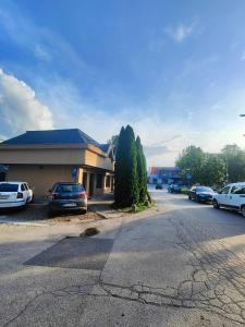 a parking lot with cars parked in front of a building at Parrot district apartments in Nové Zámky