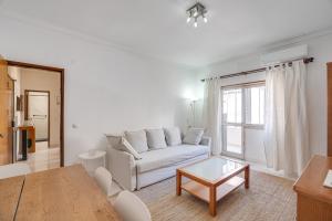 a living room with a white couch and a table at Hopstays - Almada Saudade in Almada