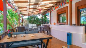 a restaurant with tables and chairs and a bar at Ephesus Palaces in Selçuk