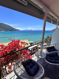 a balcony with chairs and a view of the ocean at Ponti Bay Apartments in Vasiliki
