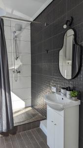 a bathroom with a sink and a shower and a mirror at Pine forest house 6 in Gauja +40 photos