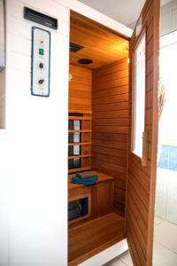 a sauna with wood paneling and a window at Ferienwohnung Viola mit Wallbox in Schneverdingen
