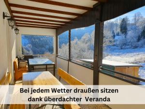 a room with a large window with a view of a snowy mountain at Ferienhaus Grimme - 350m2, 18 Betten - mit Indoorspielplatz, Pool, großer Terrasse, Grill, Sauna, Kicker, Dart, uvm - ideal für Familien in Schmallenberg +59 photos