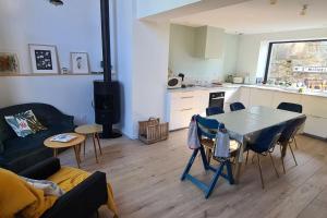 a living room with a table and a kitchen at Villa avec vue Mont Saint-Michel in Saint-Jean-le-Thomas +5 photos