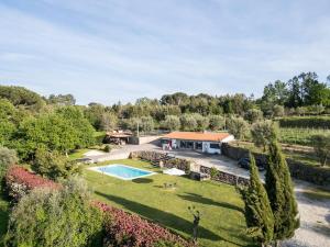 an aerial view of a house with a swimming pool at Barrocal Nature Houses in Nelas