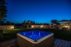 a hot tub in a backyard at night at Masseria Monte Pizzuto in Ceglie Messapica