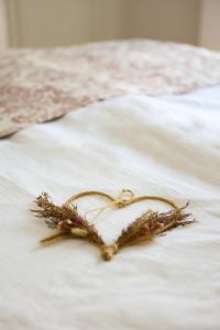 a heart shaped decoration on a white bed at APART HOTEL ASTERIA in Ljubljana