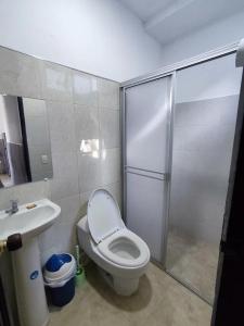 a bathroom with a shower and a toilet and a sink at Cabaña en condominio frente al mar #10 in Tolú