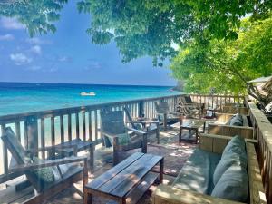 a view of the ocean from a deck with benches at Marazul Dive Resort-Panoramic Ocean View Town Home in Westpunt
