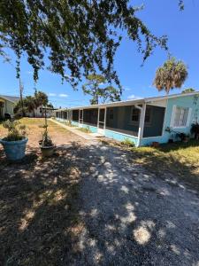 a row of houses with trees in front of them at 875 Oasis #3 in Vero Beach
