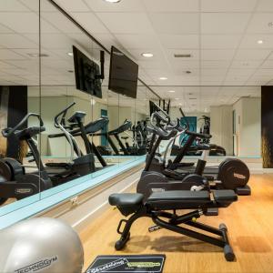 a gym with treadmills and elliptical machines at Fletcher Hotel-Restaurant Sparrenhorst-Veluwe in Nunspeet