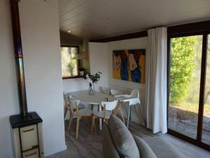a dining room with a white table and chairs at La Bella Garda in Tignale